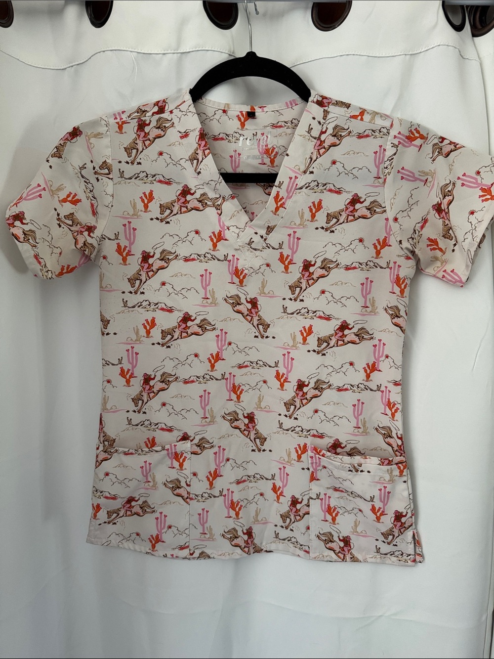 Revel scrub top with western-inspired "vintage cowgirl" print cacti and riders S